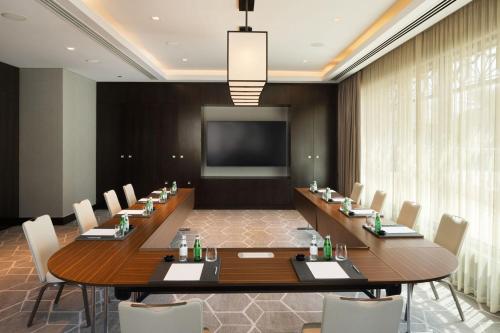 a large conference room with a large table and chairs at JW Marriott Hotel Muscat in Muscat