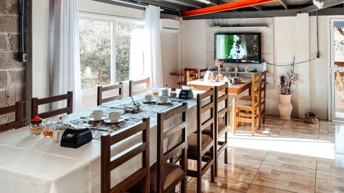 a dining room with a long table and chairs at Pousada do Bosque Bento in Bento Gonçalves