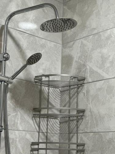 a shower rack with a shower head in a bathroom at LARDA TBILISI in Tbilisi City