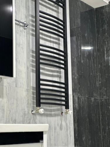 a bathroom with a shower with a window and a sink at LARDA TBILISI in Tbilisi City