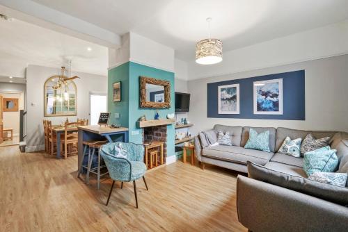 a living room with a couch and a table at 3-Bedroom Stylish & Spacious Townhouse, Perfect for Groups and Family, Sleeps 6 with Free On-Street Parking Permit, Southsea - WORK CONTRACTORS OFFER AVAILABLE! - by Blue Puffin Stays in Portsmouth