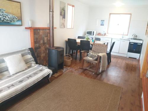 a living room with a couch and a kitchen at Casa Vesta Mar in San Antonio