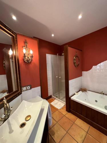 a large bathroom with a tub and a sink at La Flor del Granado in Torrijos