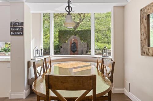 a dining room with a table and chairs and a window at Grand English Style Home in Chilliwack