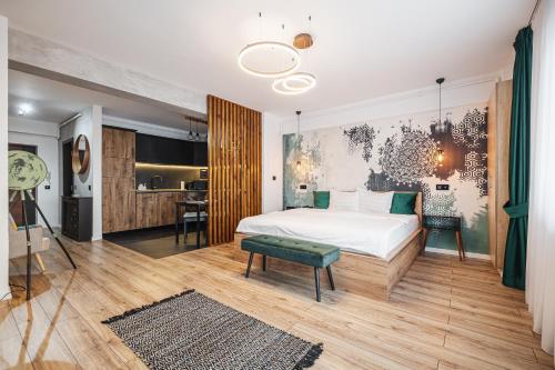 a bedroom with a large bed and a kitchen at A Guesthouse Sibiu in Sibiu