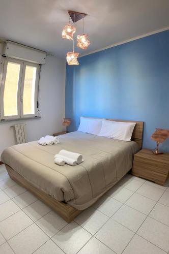 a bedroom with a bed with two towels on it at Residence La Peonia in Sassari