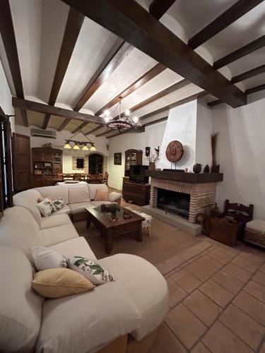 a living room with two couches and a fireplace at La Flor del Granado in Torrijos