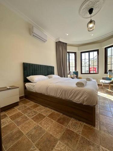 a bedroom with a large bed in a room at 1/ Antica jabalal-lwebdeh in Amman
