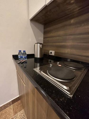 a kitchen counter with a sink and water bottles on it at 1/ Antica jabalal-lwebdeh in Amman