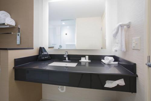 a bathroom with a sink and a large mirror at Fairfield Inn & Suites by Marriott Burlington in Burlington
