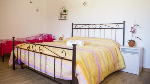 a bedroom with a bed with a yellow and purple blanket at Tenute Donna Franca in Elice