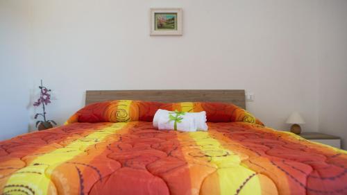 a bedroom with a large bed with two pillows at Tenute Donna Franca in Elice