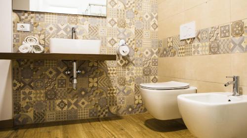 a bathroom with a white toilet and a sink at Tenute Donna Franca in Elice