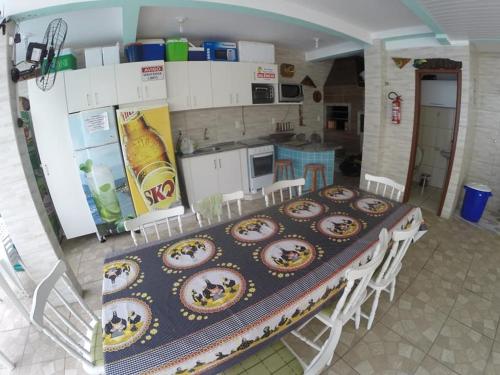 a kitchen with a table with plates of food on it at Residencial Vovó Luiz in Florianópolis