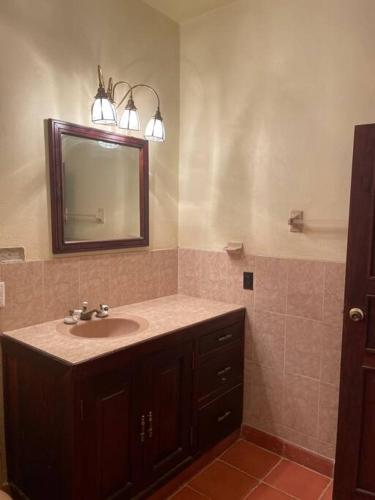 a bathroom with a sink and a mirror at Casa Mex in Pisté
