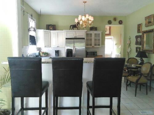 a kitchen with a bar with chairs and a table at Kathy's Place - Pet Fee Additional Charge in Lexington