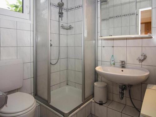 a bathroom with a shower and a sink and a toilet at Attractive bungalow at the North Sea in Warwerort in Warwerort