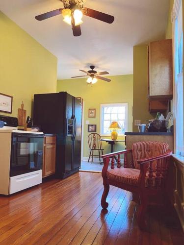 a kitchen with a refrigerator and a table in it at JW's LOFT - Pet Fee Additional Charge in Lexington