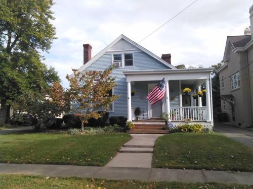 a blue house with an american flag on the porch at JW's LOFT - Pet Fee Additional Charge in Lexington