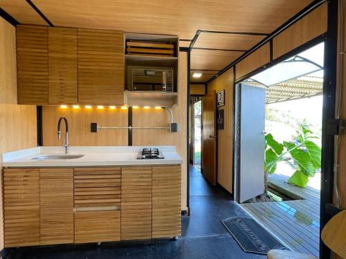 a kitchen with wooden cabinets and a sink at EL PAISAJE MAS SOÑADO in El Retiro