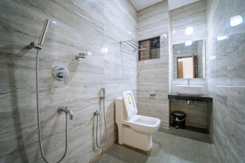 a bathroom with a shower and a toilet and a sink at Darsy Residency in Agonda