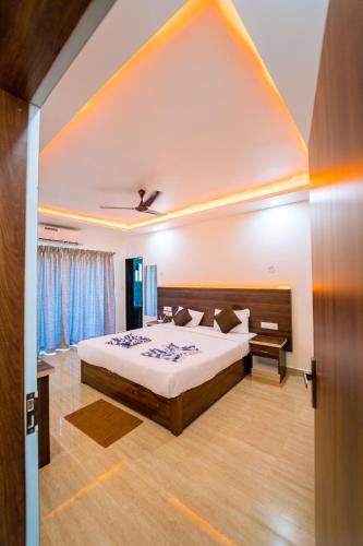 a bedroom with a large bed in a room at Darsy Residency and beach cottages in Agonda