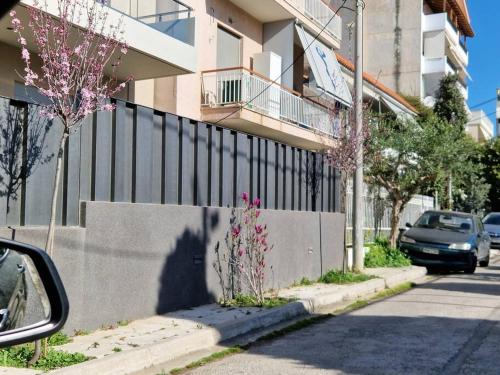 a car parked on a street next to a fence at Διαμέρισμα 130 τμ in Athens