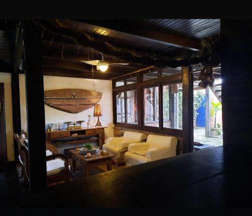 a living room with a couch and a table at Pousada Icthus in Cabo Frio