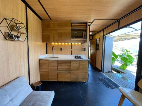 a kitchen in a tiny house with a sink at EL PAISAJE MAS SOÑADO in El Retiro