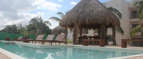 a group of chairs sitting next to a swimming pool at Playa y Luna in Progreso