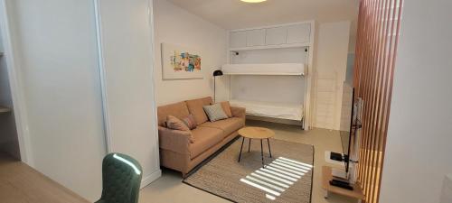 カレタ・デ・ファマラにあるSabbia Suites Casa Brisaの小さなリビングルーム(ソファ、テーブル付)