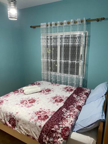 a bed in a blue room with a window at House for rent Jurgen in Golem