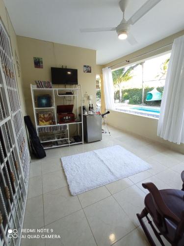 a living room with a large window and a white rug at Paraiso Hortensia Ecolodge in Santiago de los Caballeros