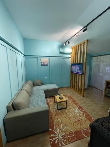 a living room with a couch and a tv at House for rent Jurgen in Golem