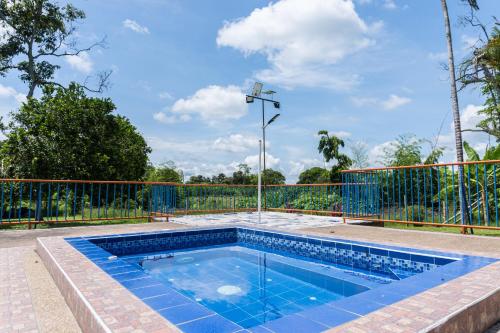 una piscina frente a una valla en De La Vega Hotel Campestre, en Montenegro