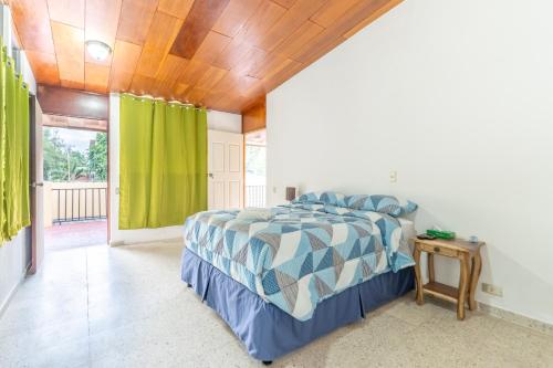 a bedroom with a bed and a wooden ceiling at Volcano Hostal y Restaurante in San Salvador