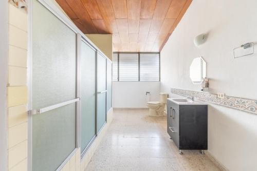 a bathroom with a sink and a toilet at Volcano Hostal y Restaurante in San Salvador
