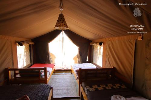 a room with two beds in a tent at Oseki Maasai Mara Camp in Narok