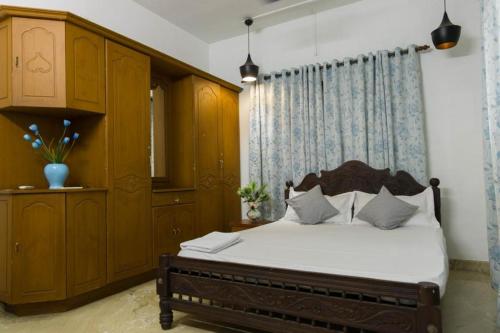 1 dormitorio con 1 cama, vestidor y 1 cama sidx sidx sidx sidx sidx sidx en Kichu’s house, en Ernakulam