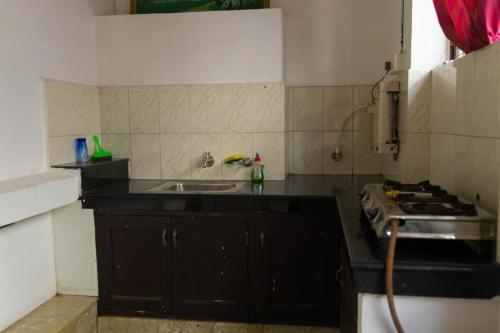 a kitchen with a sink and a stove at Kichu’s house in Ernakulam