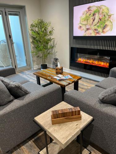 a living room with two couches and a fire place at Woodside-Filey in Filey