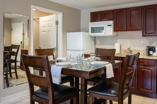 a kitchen with a table and chairs and a kitchen with a counter at D. Hotel Suites & Spa in Holyoke