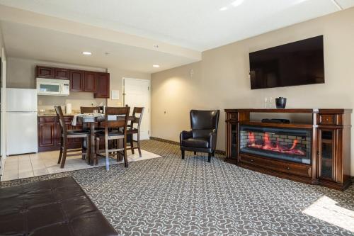 a living room with a fireplace and a dining room at D. Hotel Suites & Spa in Holyoke