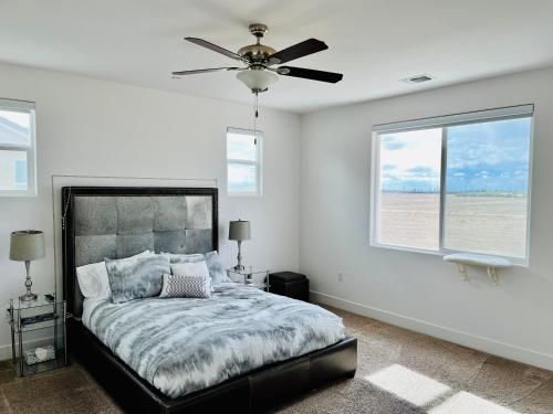 a bedroom with a bed and a ceiling fan at Modern Ripon Home - Whole House with Garage in Ripon