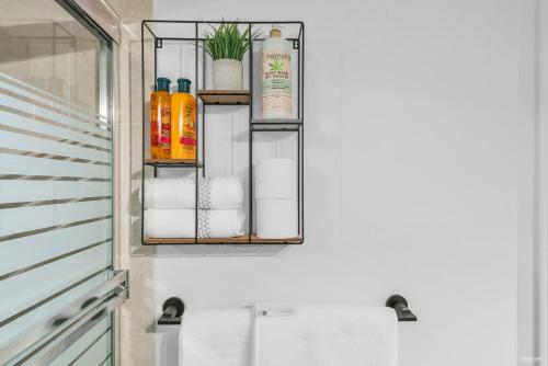 a bathroom with a rack with towels and oils at Chic 1BR Condo in Coal Harbour in Vancouver