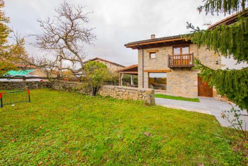 a stone house with a yard and a building at Egur Etxe I Caserío Vasco I Jardín I Porche I BBQ I Chimenea in Zárate