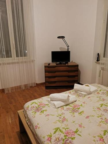 una camera con letto e TV su un comò di La Casetta a Roma