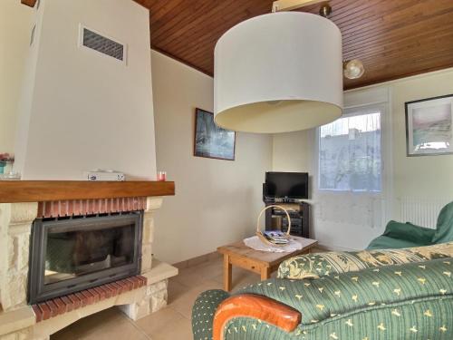 a living room with a couch and a fireplace at Maison d'Ys à 500 m de la plage in Saint-Nic