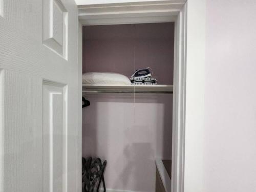 a room with a bed and a phone on a shelf at Modern Island Serenity!-Pet-Friendly villa in Hilton Head Island