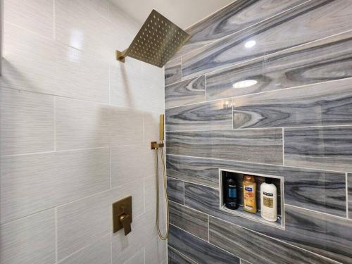 a bathroom with a shower with a wooden wall at Modern Island Serenity!-Pet-Friendly villa in Hilton Head Island